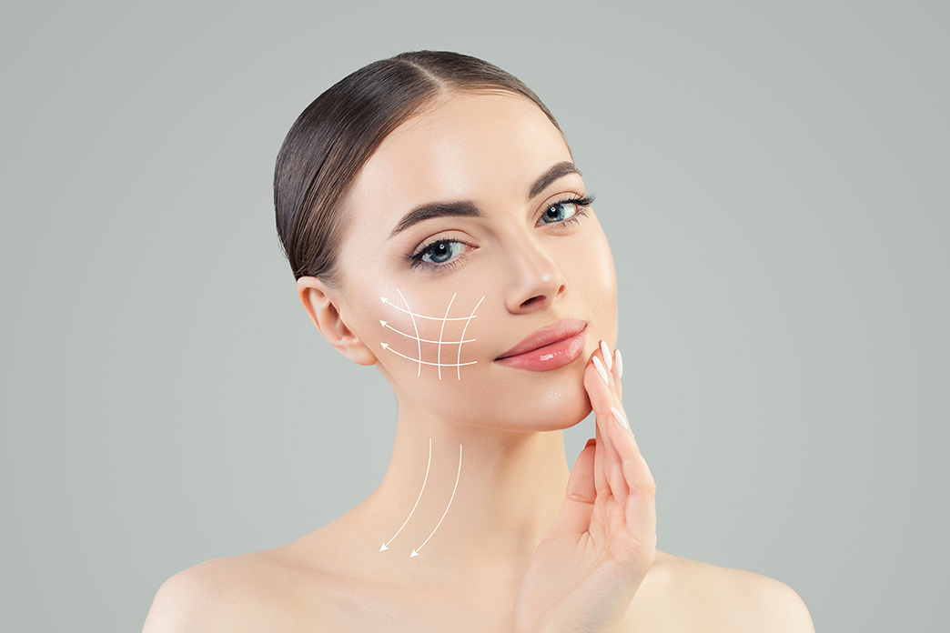 Beautiful female patient with lines indicating plastic surgery work done.